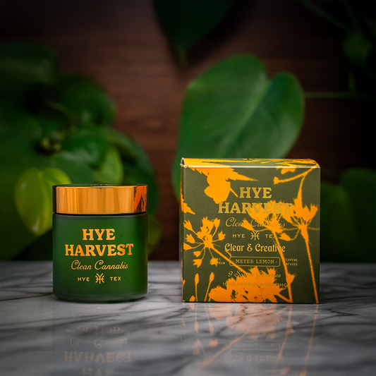 Close-up of a Texas-made gummies box on a marble counter, with trees and greenery softly blurred in the background.